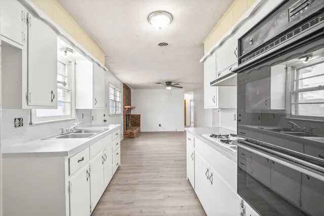 a kitchen with a sink stove and cabinets