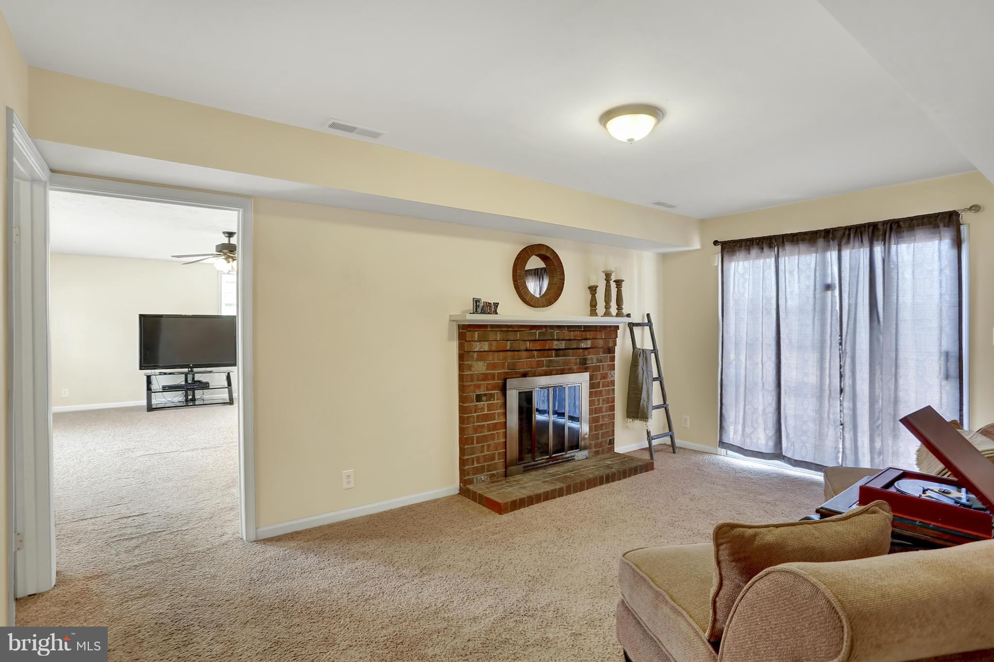 Walk-out rec rm / den with cozy wood-burning FP