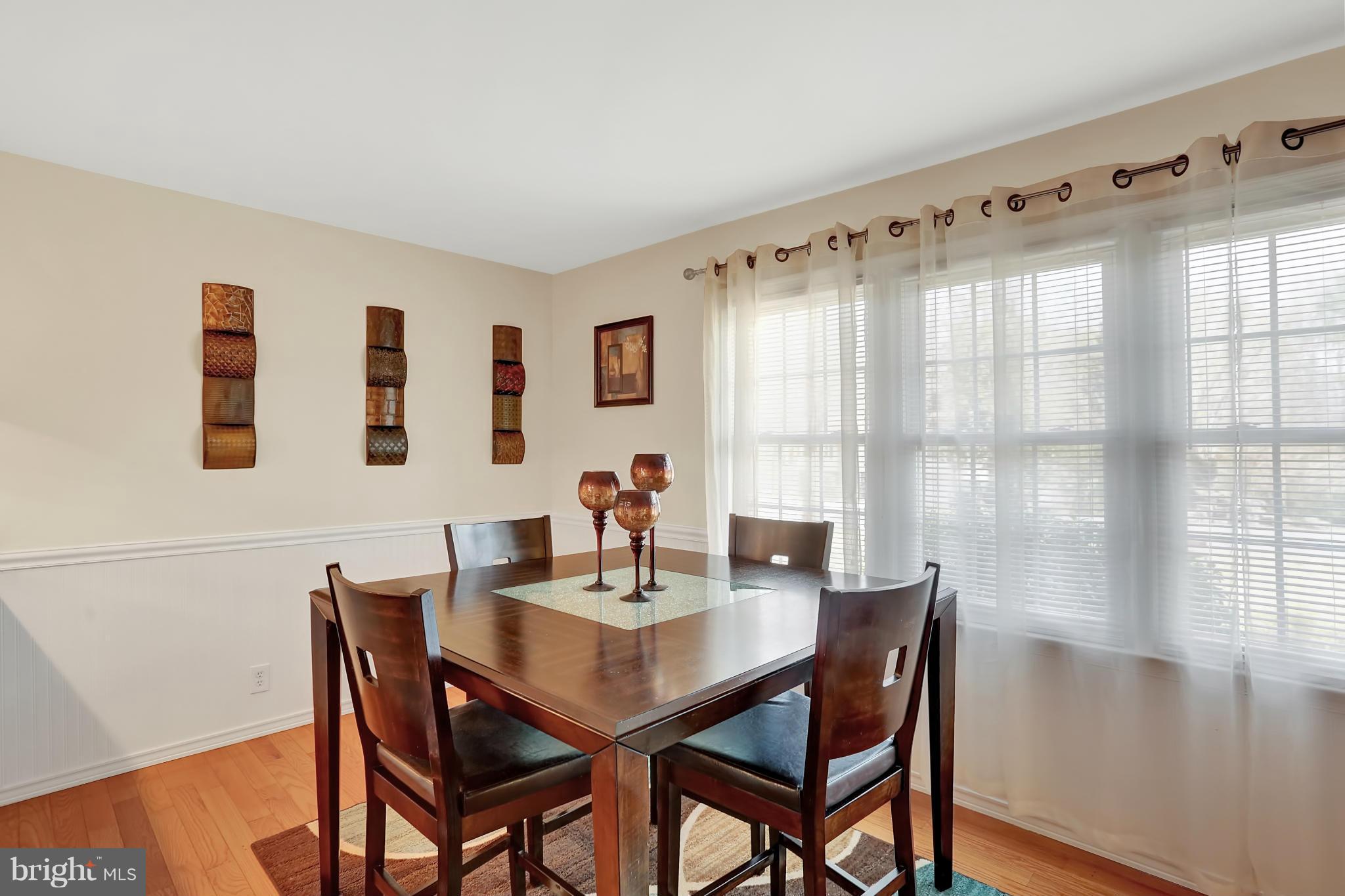 Sunny dining room w/HW floor