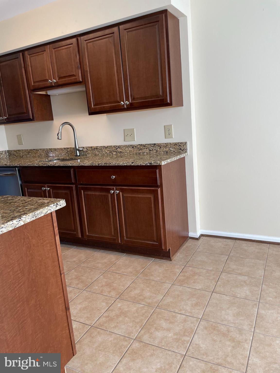 12405 Gooderham Way Gaithersburg, MD 20878 - Photo 7 of 31 a kitchen with stainless steel appliances granite countertop a sink and cabinets