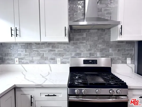 a stove top oven sitting inside of a kitchen