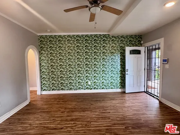 a view of a room with wooden floor
