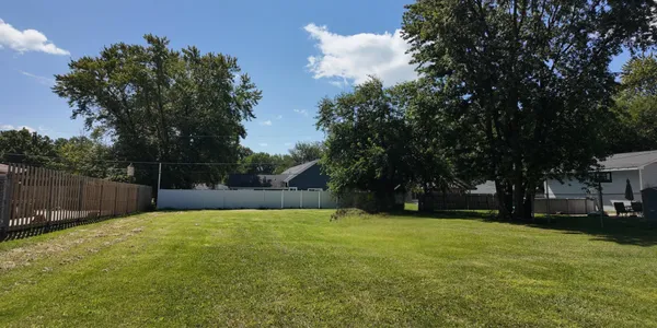 a view of a garden with wooden fence