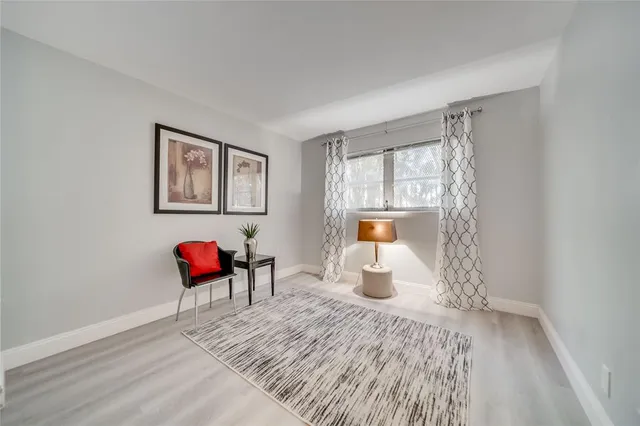 a view of a room with wooden floor and furniture