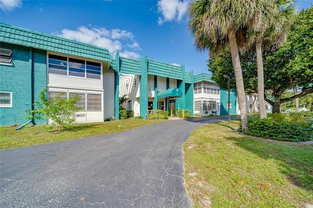 a house with palm trees in front of it