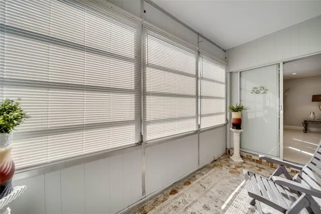 a view of a room with furniture and wooden floor