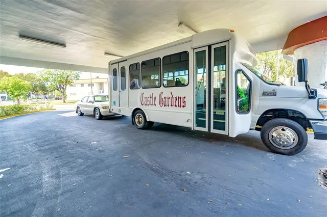 a swimming pool with outdoor seating and barbeque area in the back
