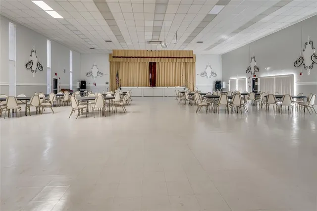 a living room with furniture a rug and a floor to ceiling window