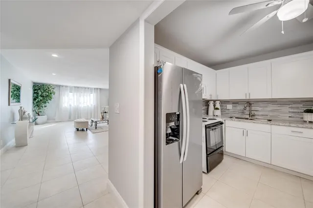 a kitchen with refrigerator and cabinets