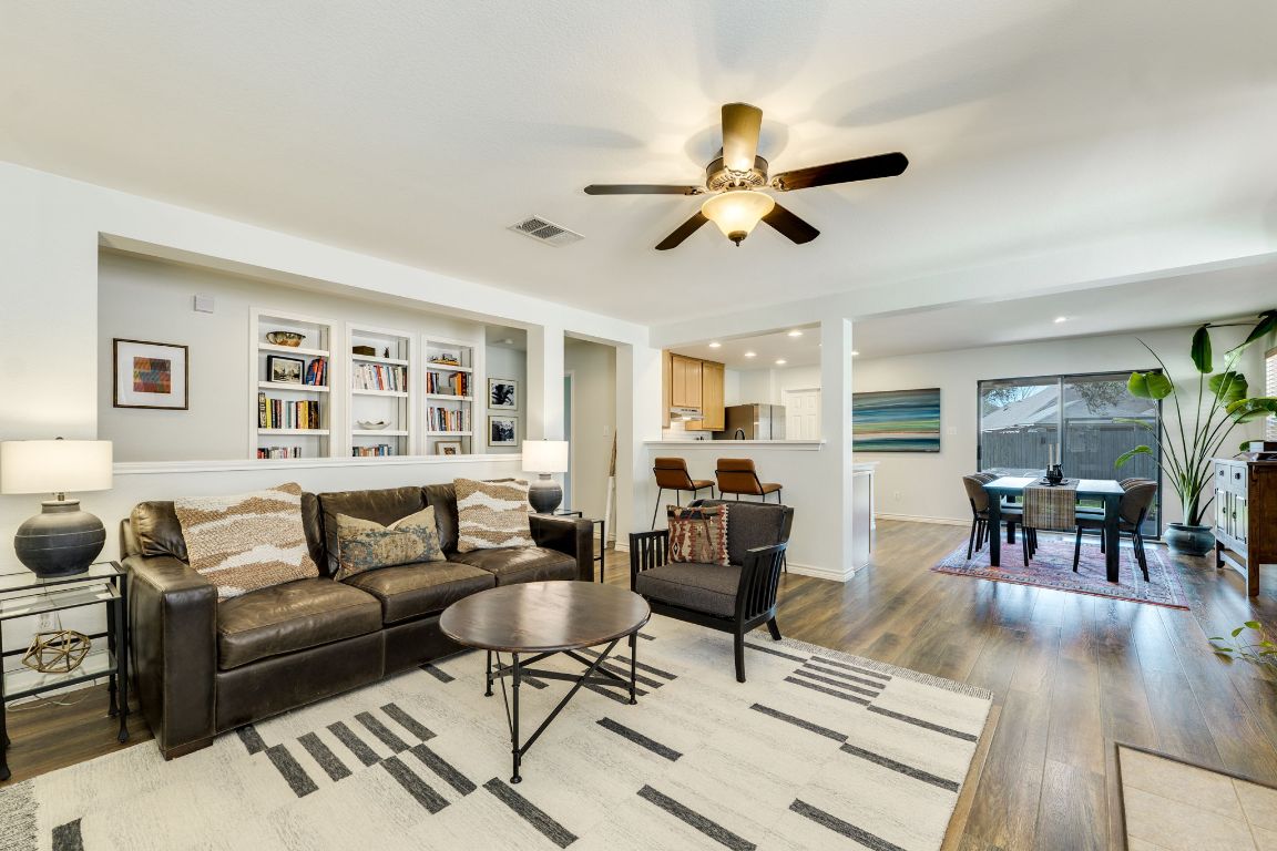 a living room with furniture and a wooden floor