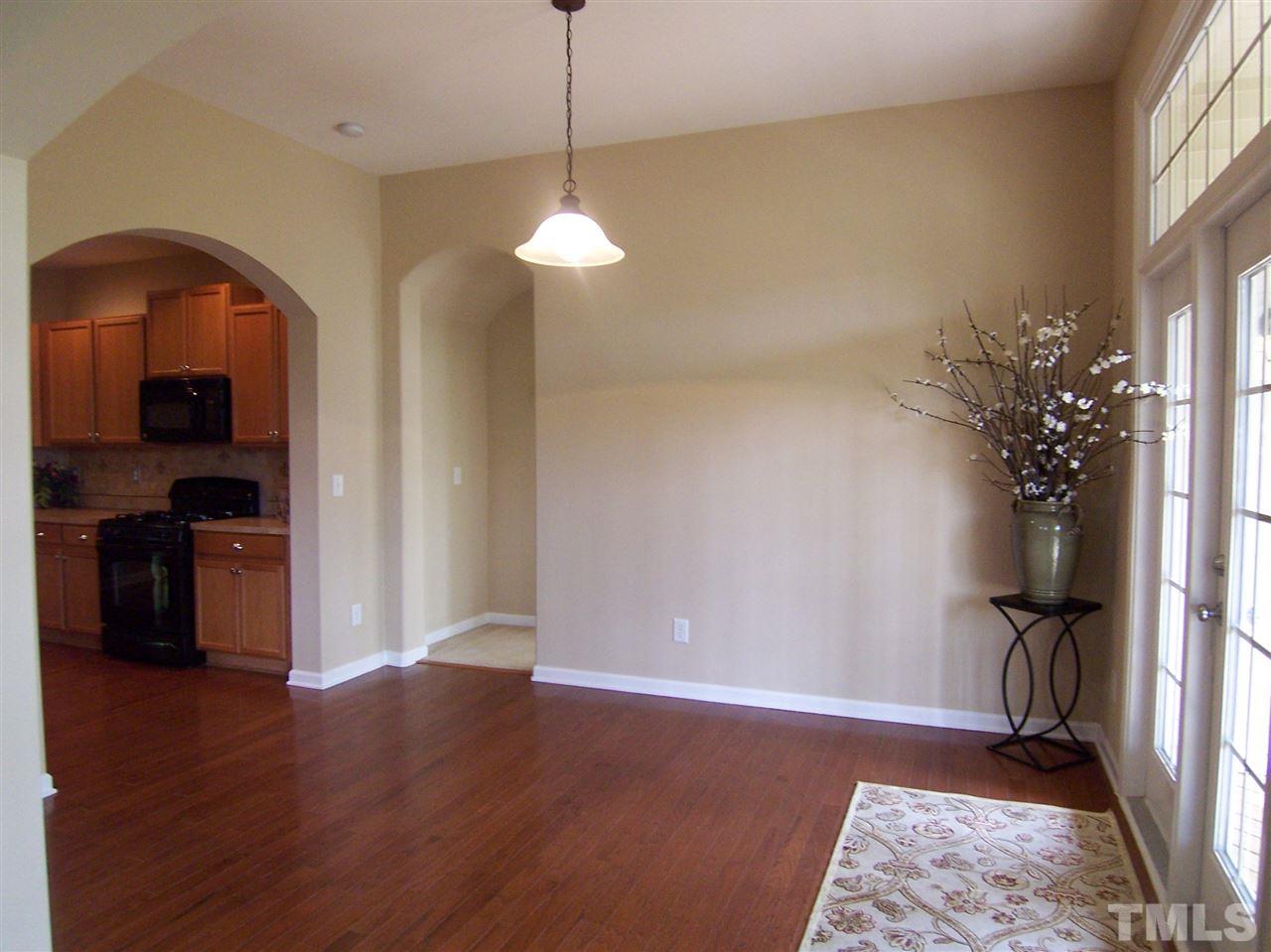 6157 Blakeman Lane Raleigh, NC 27617 - Photo 12 of 25 a view of empty room with wooden floor and fan