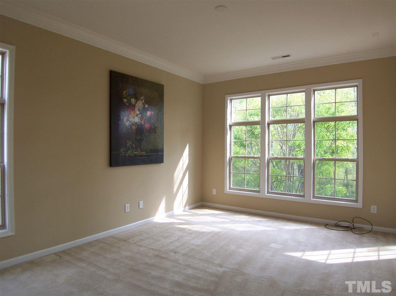 6157 Blakeman Lane Raleigh, NC 27617 - Photo 14 of 25 a view of an empty room with a window