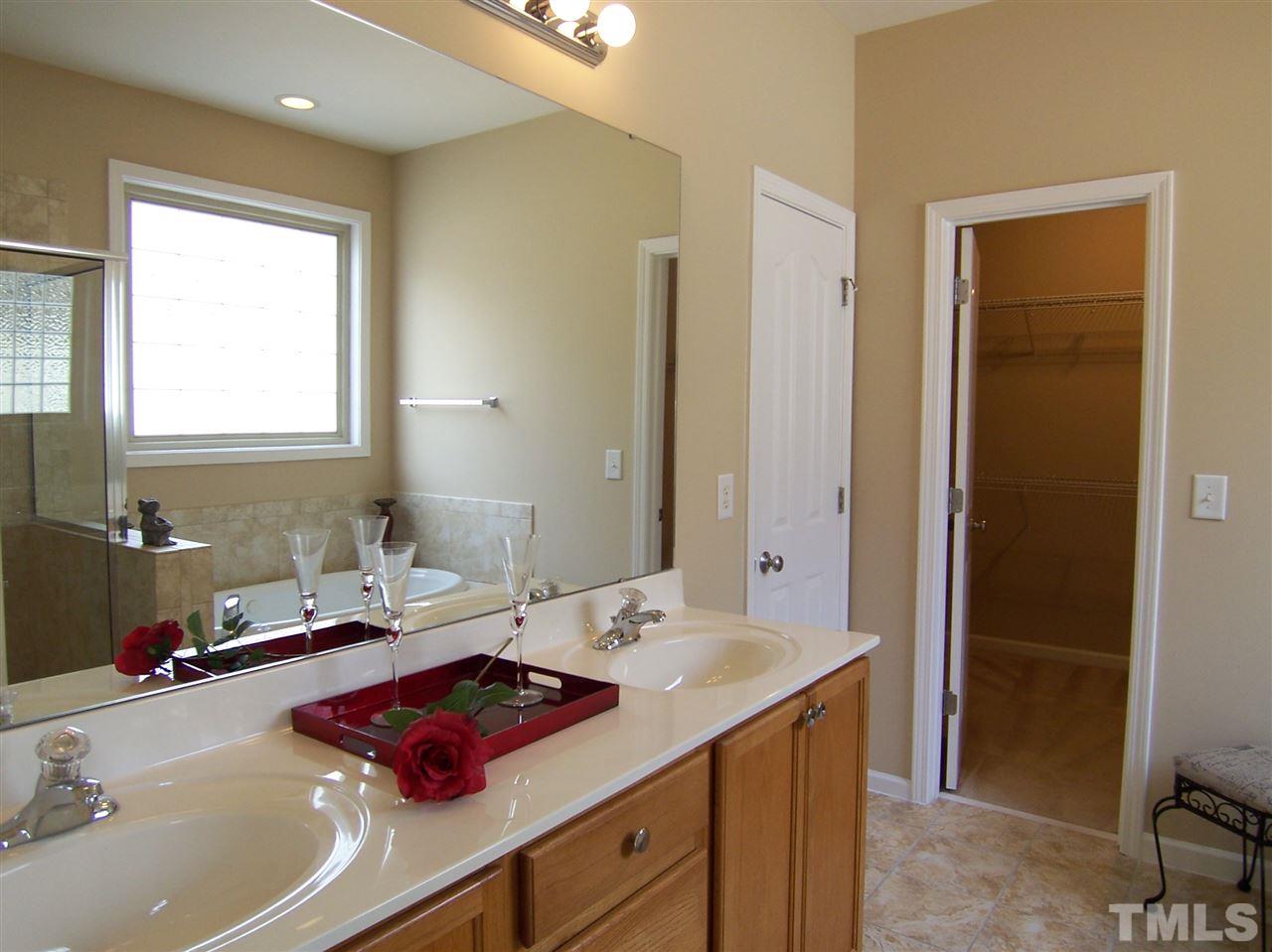 6157 Blakeman Lane Raleigh, NC 27617 - Photo 15 of 25 a bathroom with a sink and a mirror