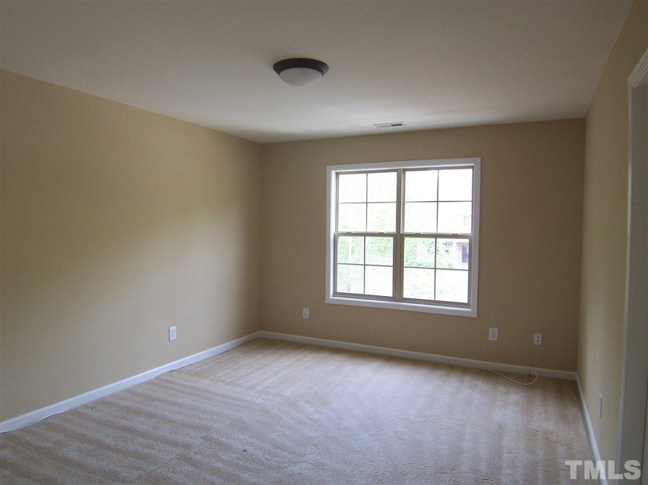 6157 Blakeman Lane Raleigh, NC 27617 - Photo 20 of 25 an empty room with wooden floor and windows