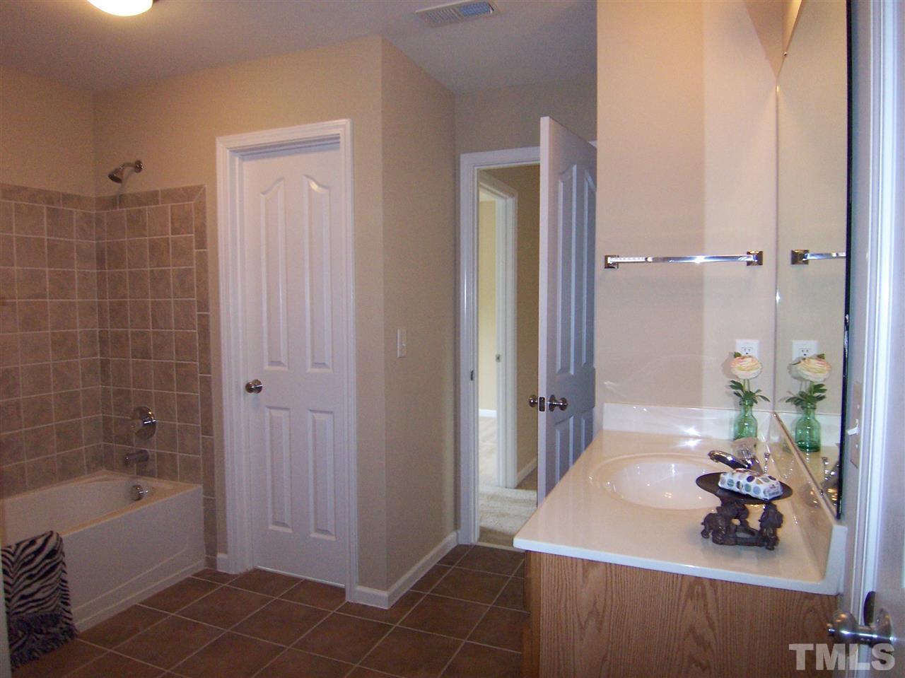 6157 Blakeman Lane Raleigh, NC 27617 - Photo 21 of 25 a bathroom with a tub and a sink