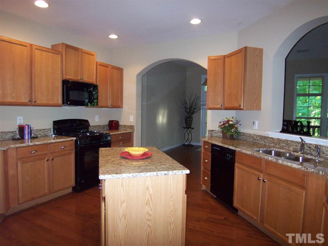 6157 Blakeman Lane Raleigh, NC 27617 - Photo 8 of 25 a kitchen with a sink stove and refrigerator