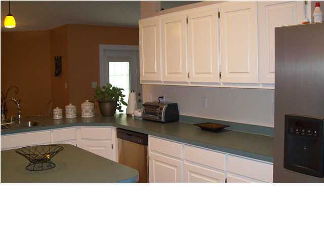 713 Riva Ridge Drive Crestview, FL 32539 - Photo 4 of 9 a kitchen with stainless steel appliances kitchen island granite countertop a sink refrigerator and cabinets