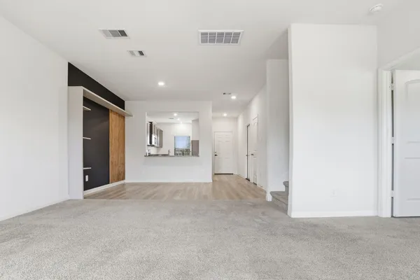 a dining room with furniture and wooden floor
