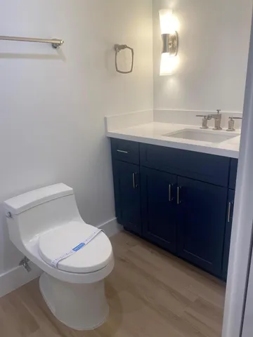 a bathroom with a toilet a sink and mirror