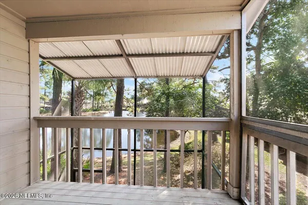 a view of a balcony with wooden floor