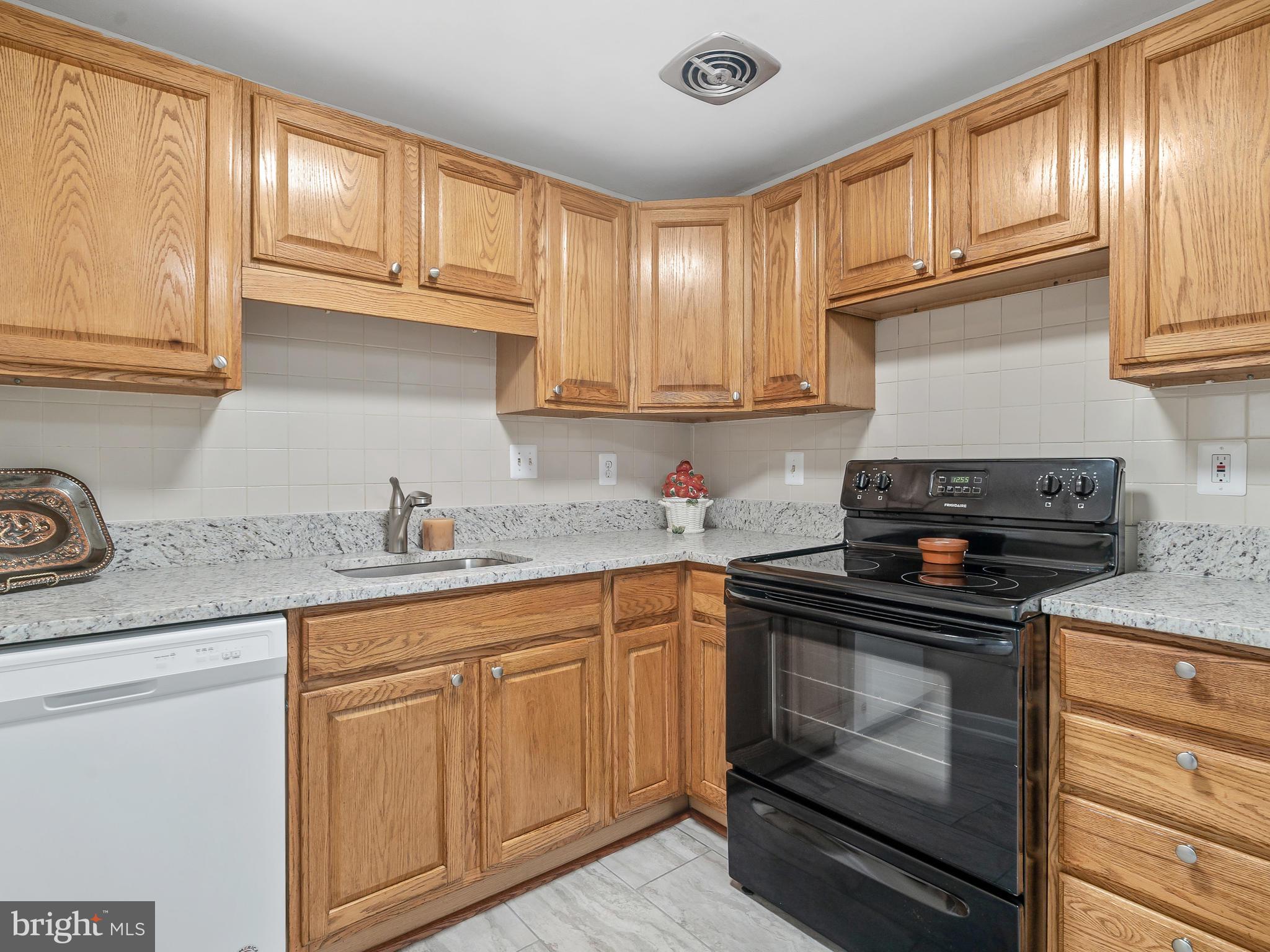 19044 Staleybridge Road Germantown, MD 20876 - Photo 11 of 30 a kitchen with granite countertop cabinets stainless steel appliances and a sink