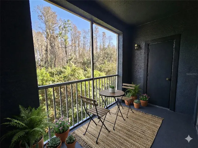 a view of a balcony with chairs and wooden floor