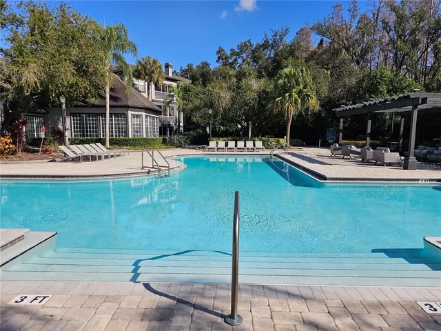 a view of a swimming pool with chairs