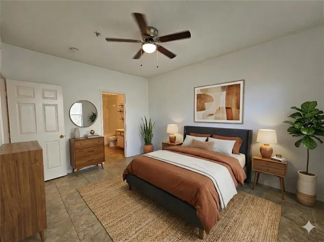 a bedroom with a bed a mirror and dresser