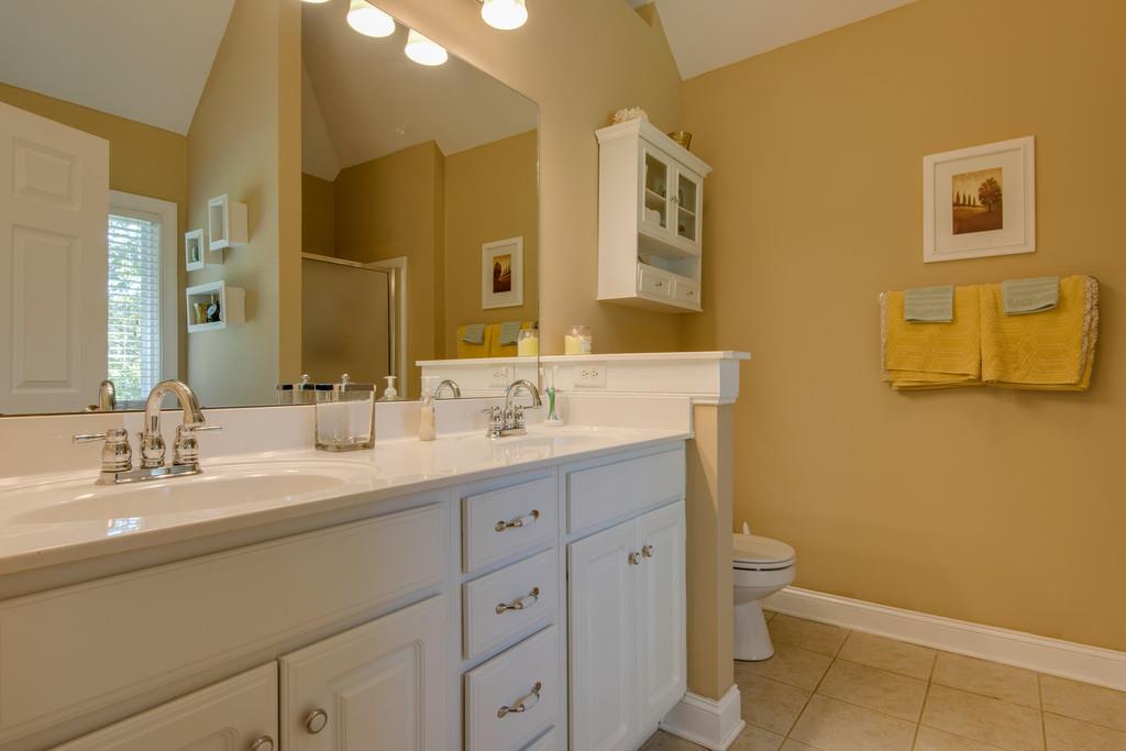 1006 Meeks Cemetery Road Burns, TN 37029 - Photo 11 of 19 a bathroom with a double vanity sink and mirror