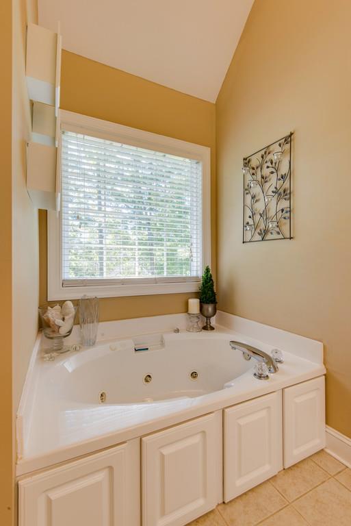 1006 Meeks Cemetery Road Burns, TN 37029 - Photo 12 of 19 a bathroom with a bathtub and a window