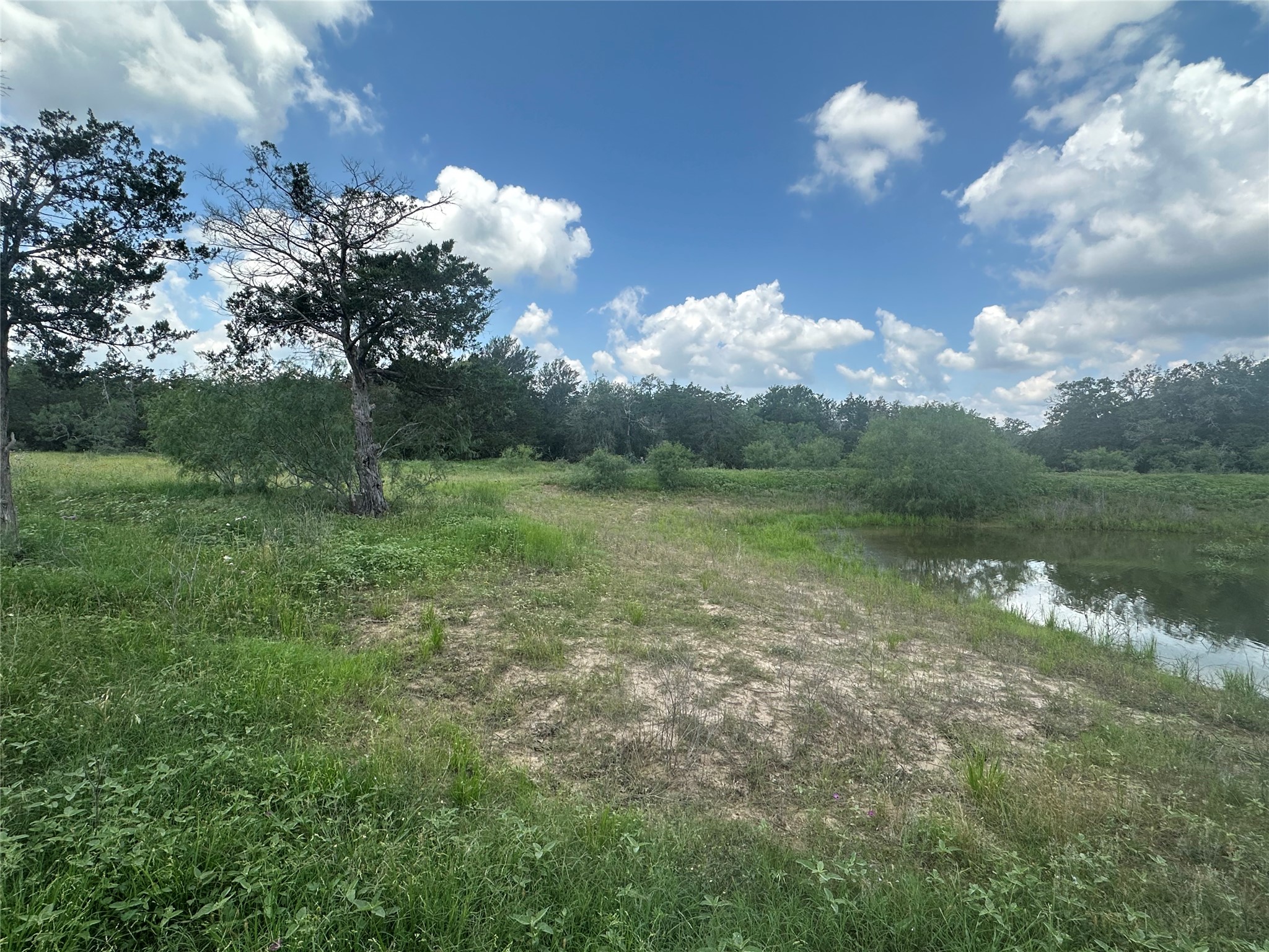 1403 Armstrong Derry Road Waelder, TX 78959 - Photo 10 of 11 a view of a lake with a big yard