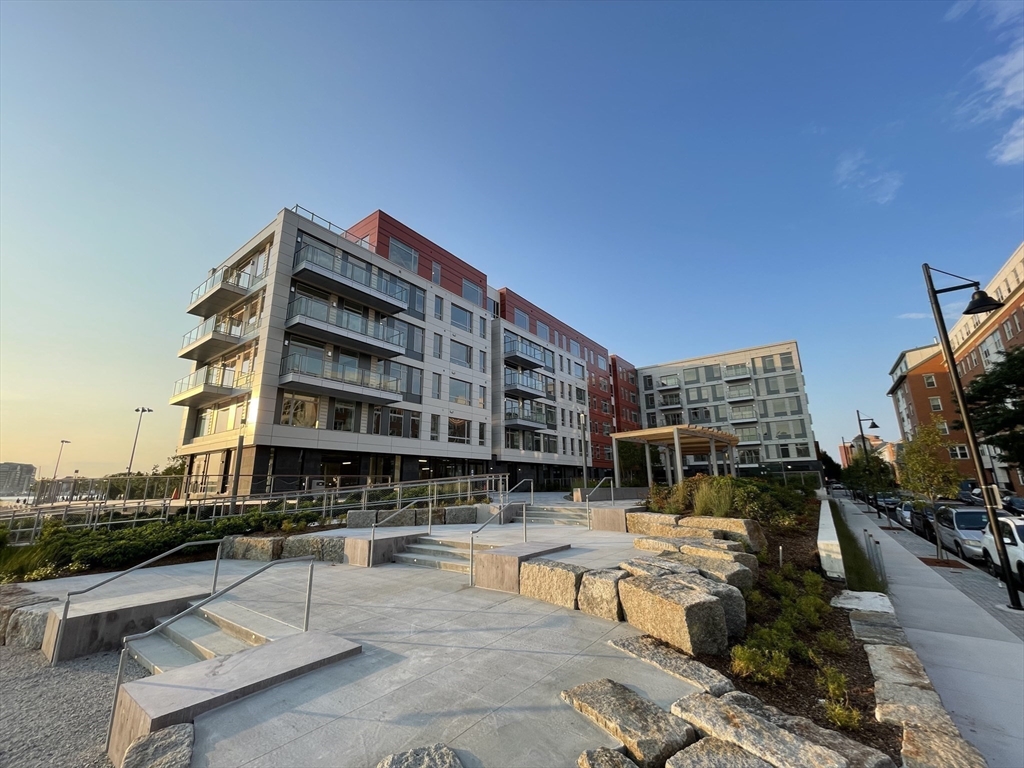99 Sumner Street, Unit 306 Boston, MA 02128 - Photo 15 of 15 a view of a swimming pool with outdoor seating and city view