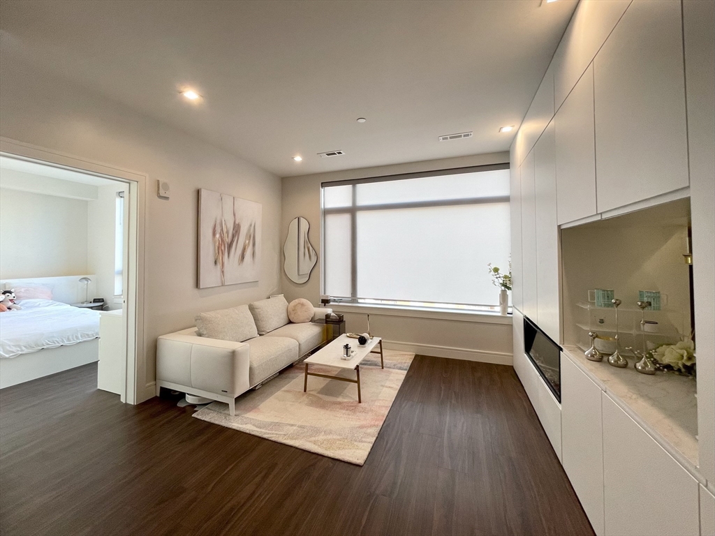 99 Sumner Street, Unit 306 Boston, MA 02128 - Photo 2 of 15 a living room with furniture and a large window