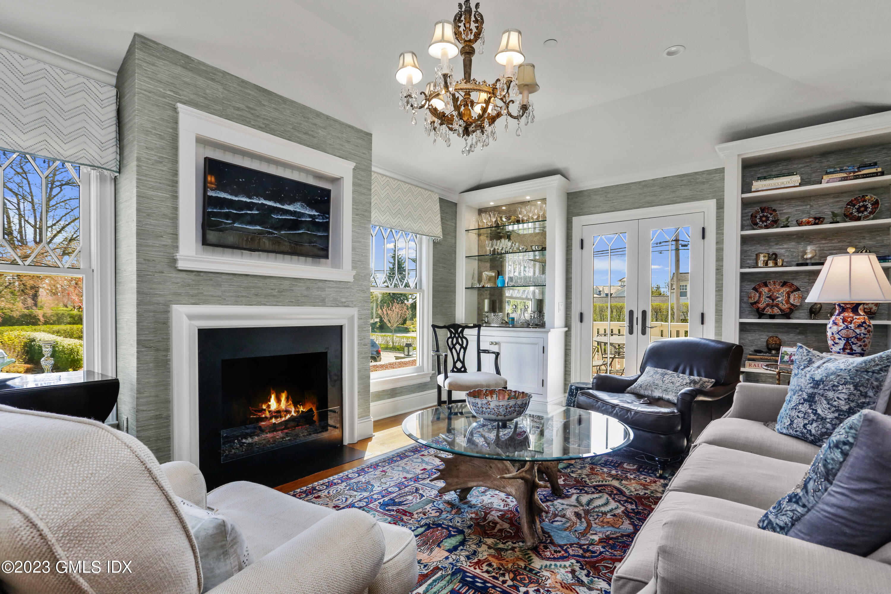 165 Shore Road, Unit A Old Greenwich, CT 06870 - Photo 1 of 28 a living room with furniture a chandelier and a fireplace