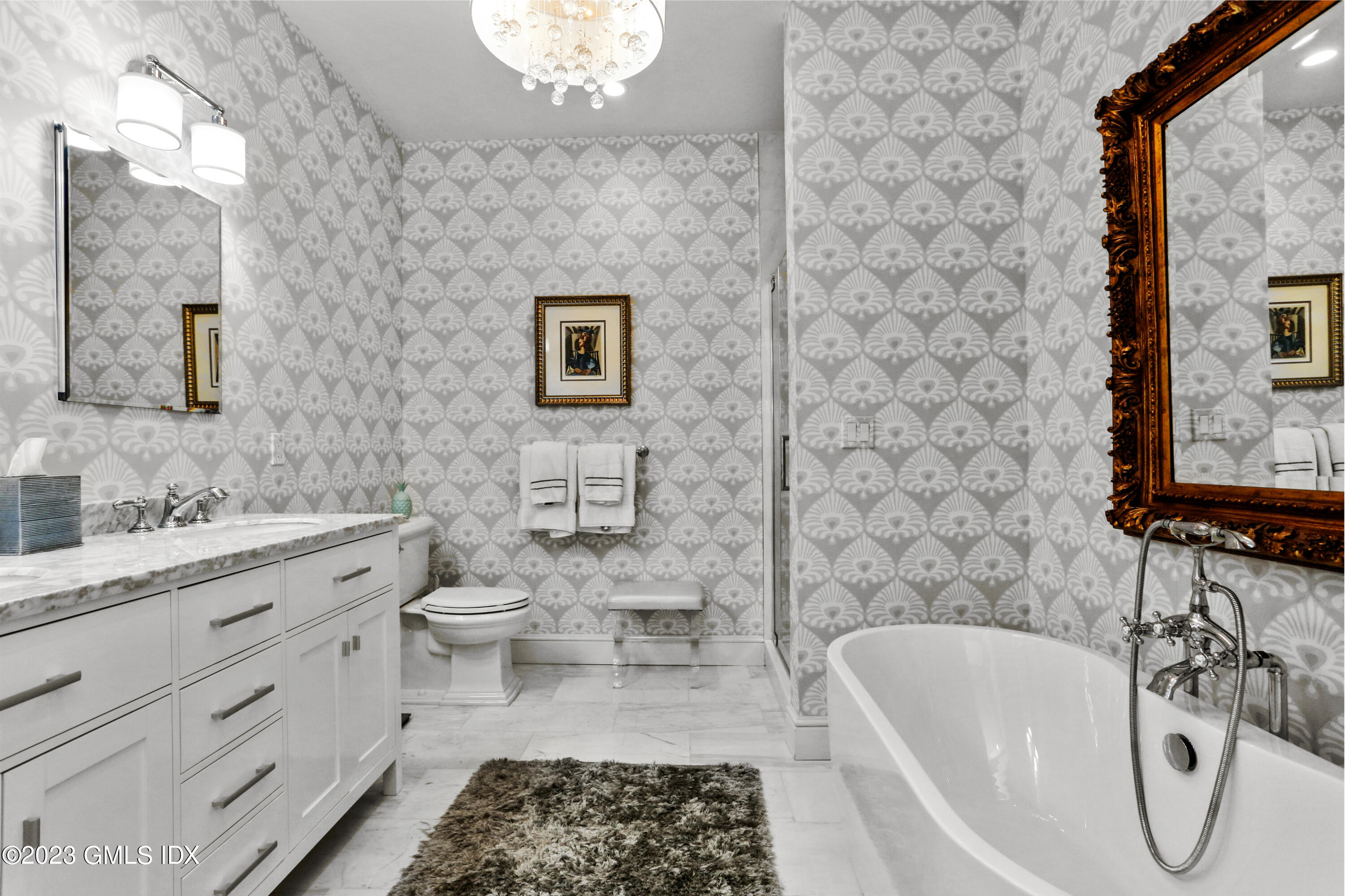 165 Shore Road, Unit A Old Greenwich, CT 06870 - Photo 12 of 28 a bathroom with a toilet a sink a mirror and a bathtub