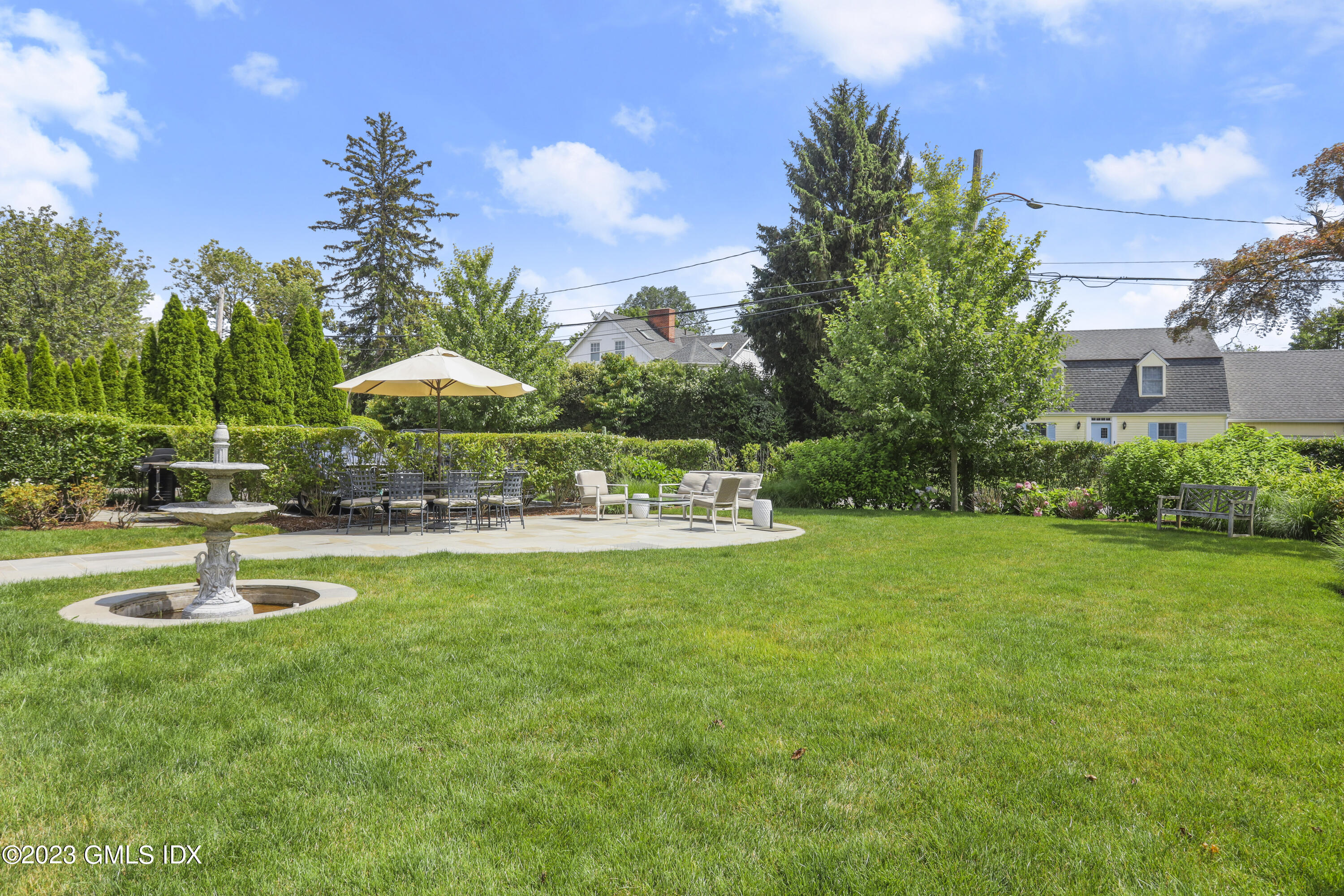 165 Shore Road, Unit A Old Greenwich, CT 06870 - Photo 19 of 28 a swimming pool with outdoor seating and yard