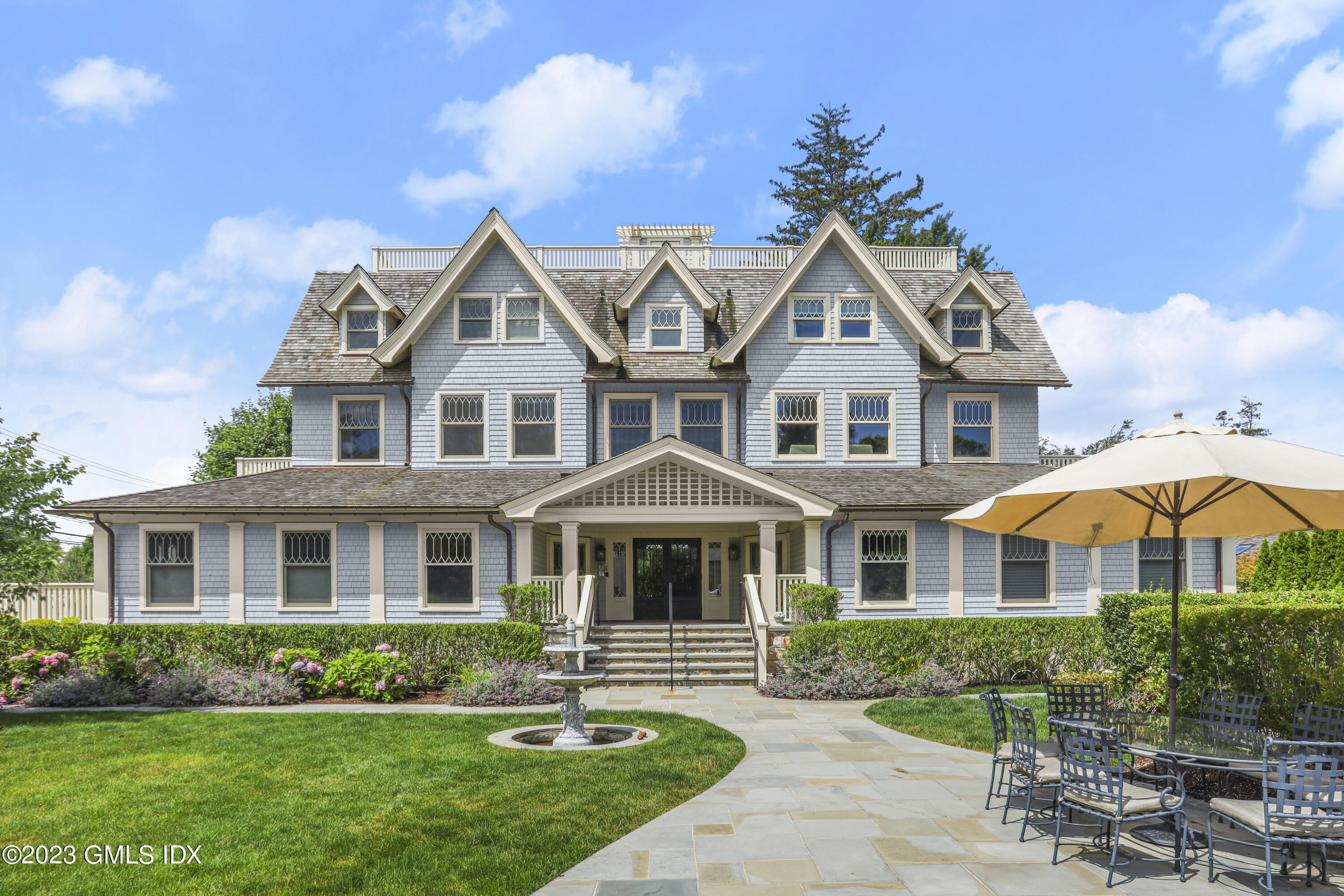 165 Shore Road, Unit A Old Greenwich, CT 06870 - Photo 2 of 28 a front view of a house with a yard