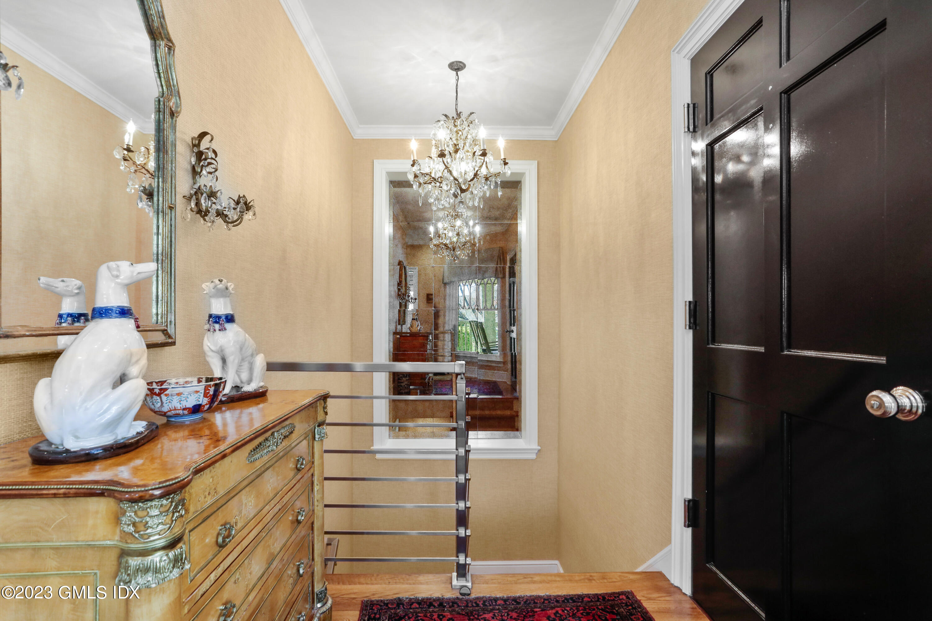 165 Shore Road, Unit A Old Greenwich, CT 06870 - Photo 5 of 28 a room with a chandelier and glass door