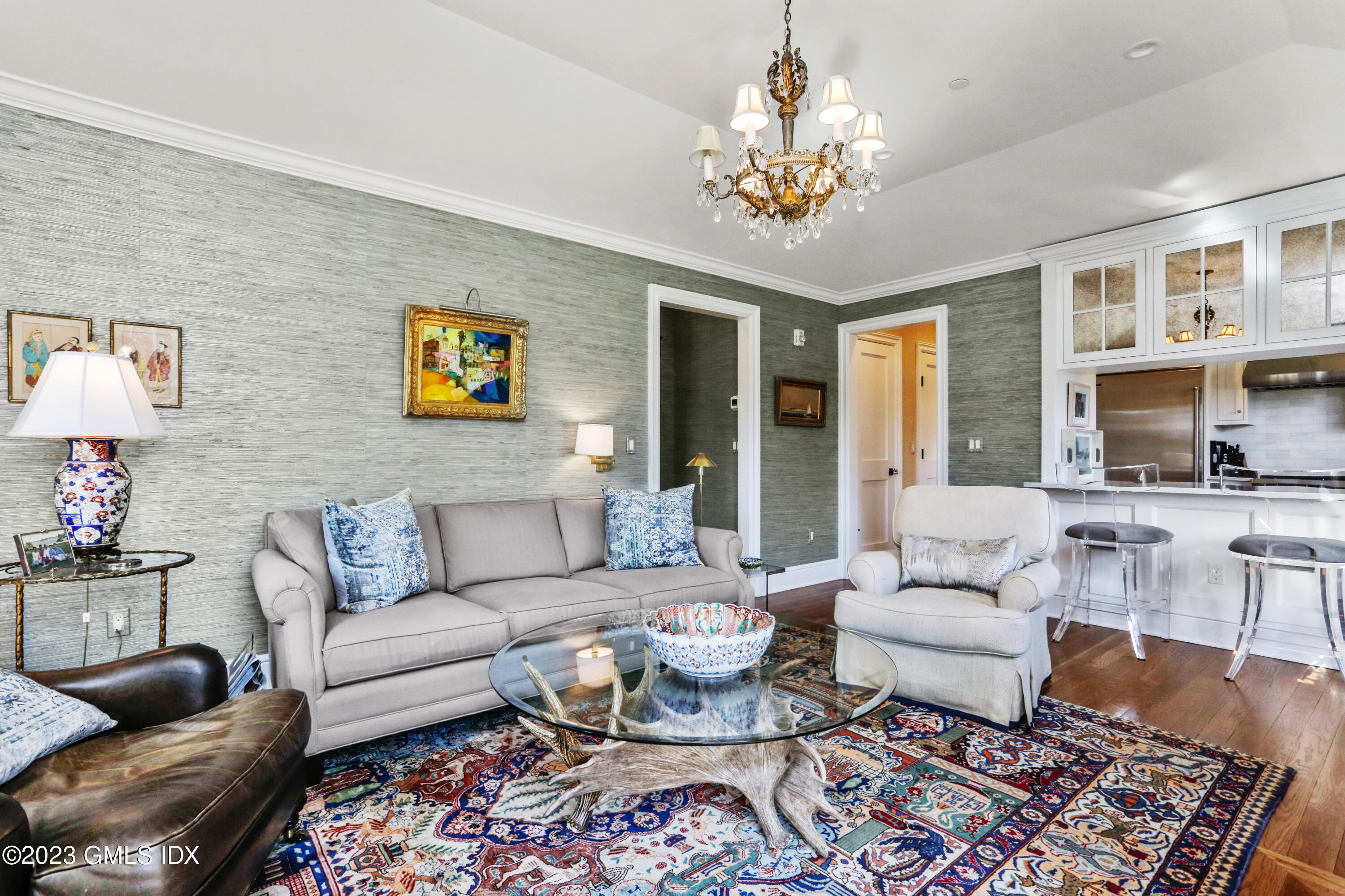 165 Shore Road, Unit A Old Greenwich, CT 06870 - Photo 6 of 28 a living room with furniture and a chandelier