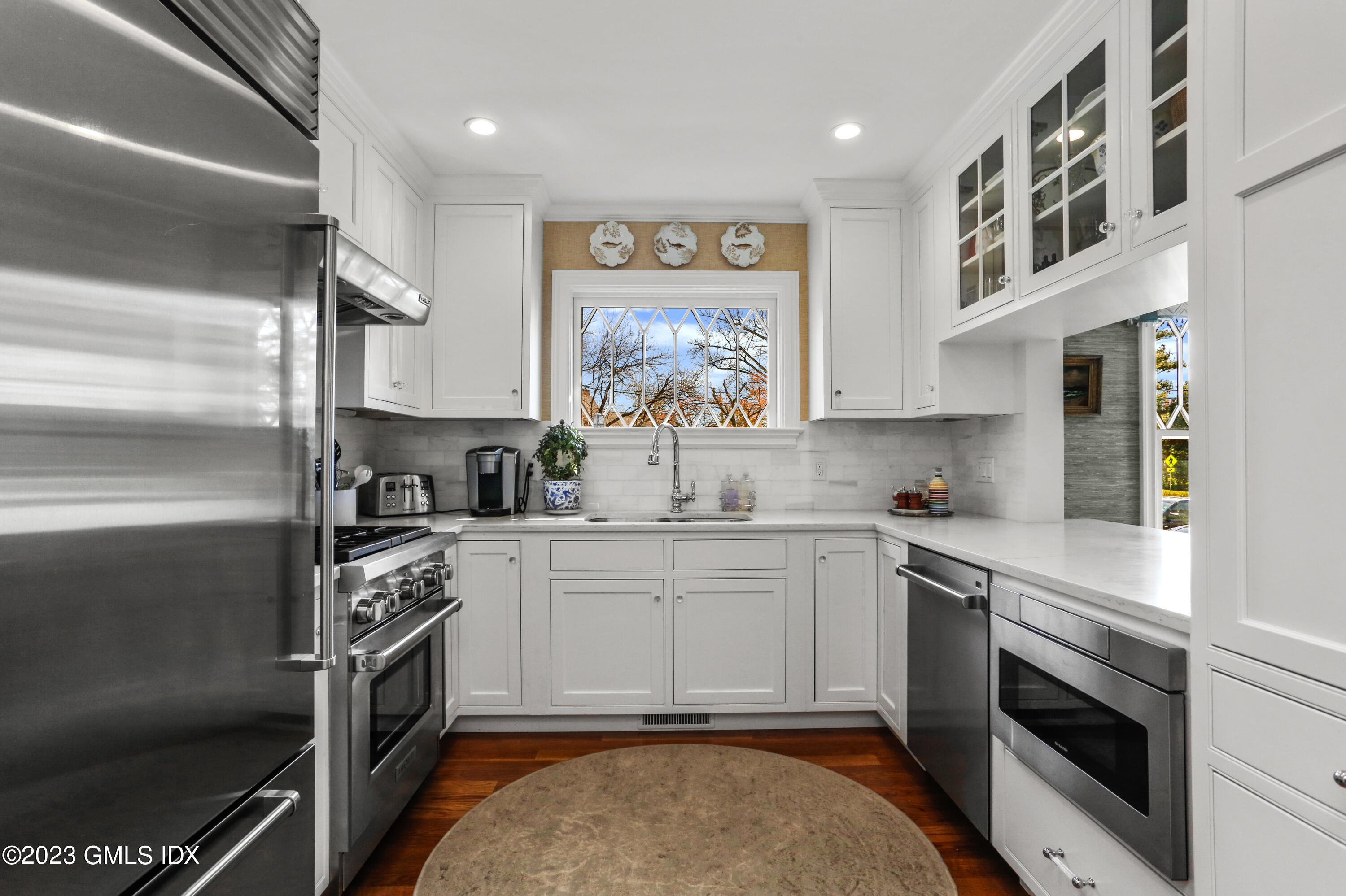 165 Shore Road, Unit A Old Greenwich, CT 06870 - Photo 7 of 28 a kitchen with a stove oven and sink