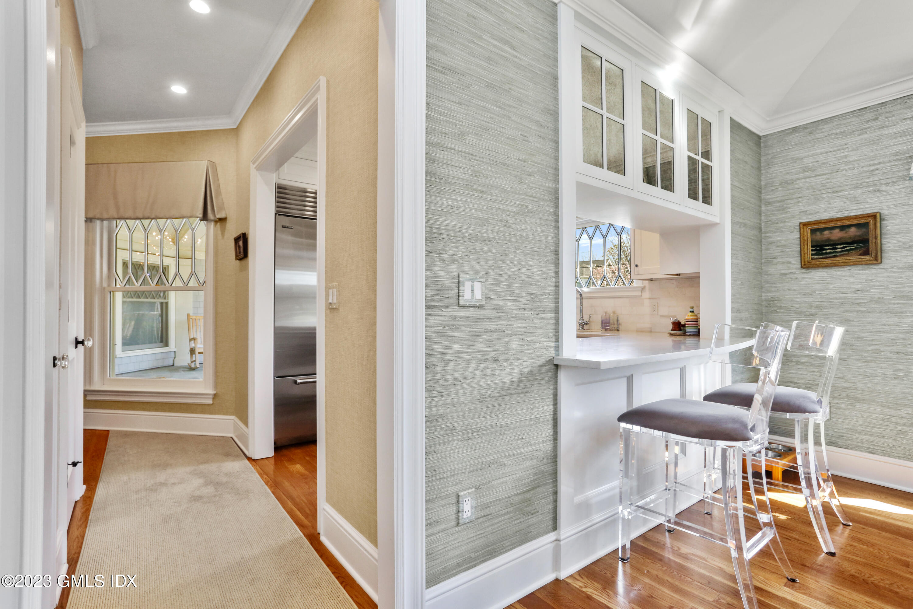 165 Shore Road, Unit A Old Greenwich, CT 06870 - Photo 8 of 28 a view of a hallway with dining room and wooden floor