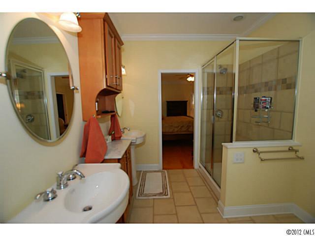 1126 Eastview Drive Charlotte, NC 28211 - Photo 12 of 15 a bathroom with a sink mirror and tub