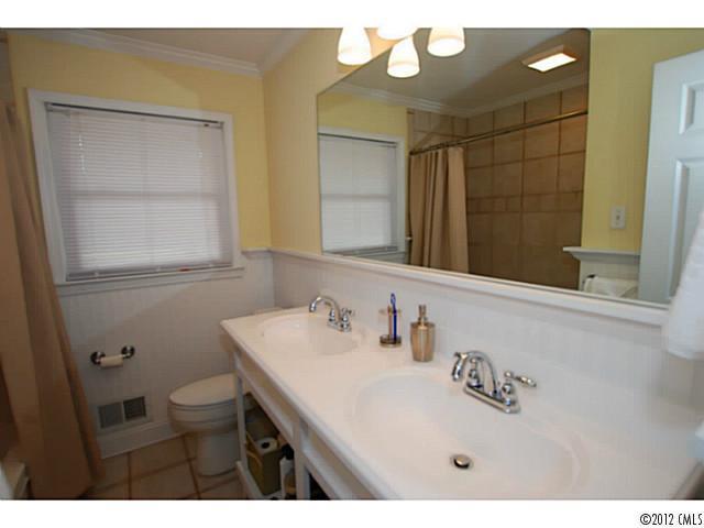 1126 Eastview Drive Charlotte, NC 28211 - Photo 14 of 15 a bathroom with a sink a toilet and a mirror