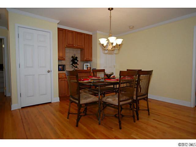 1126 Eastview Drive Charlotte, NC 28211 - Photo 4 of 15 a view of a dining room with furniture wooden floor and chandelier