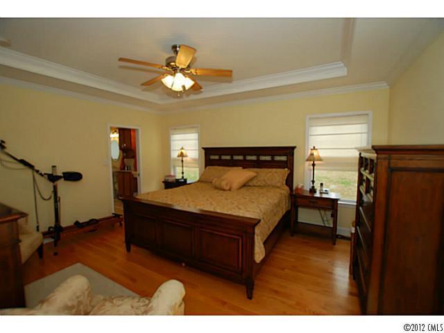 1126 Eastview Drive Charlotte, NC 28211 - Photo 8 of 15 a bedroom with a bed and a chandelier