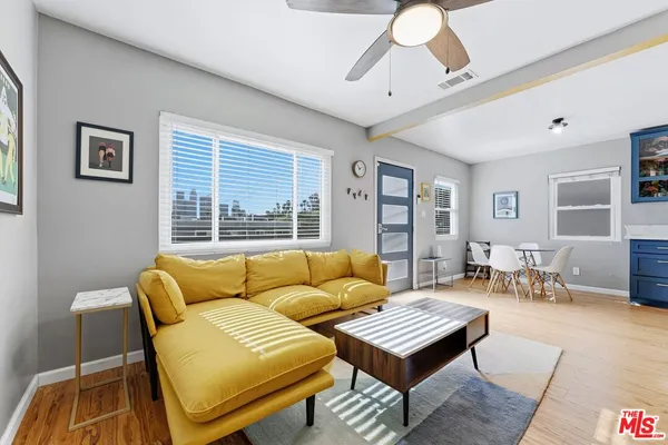 a living room with furniture and a large window