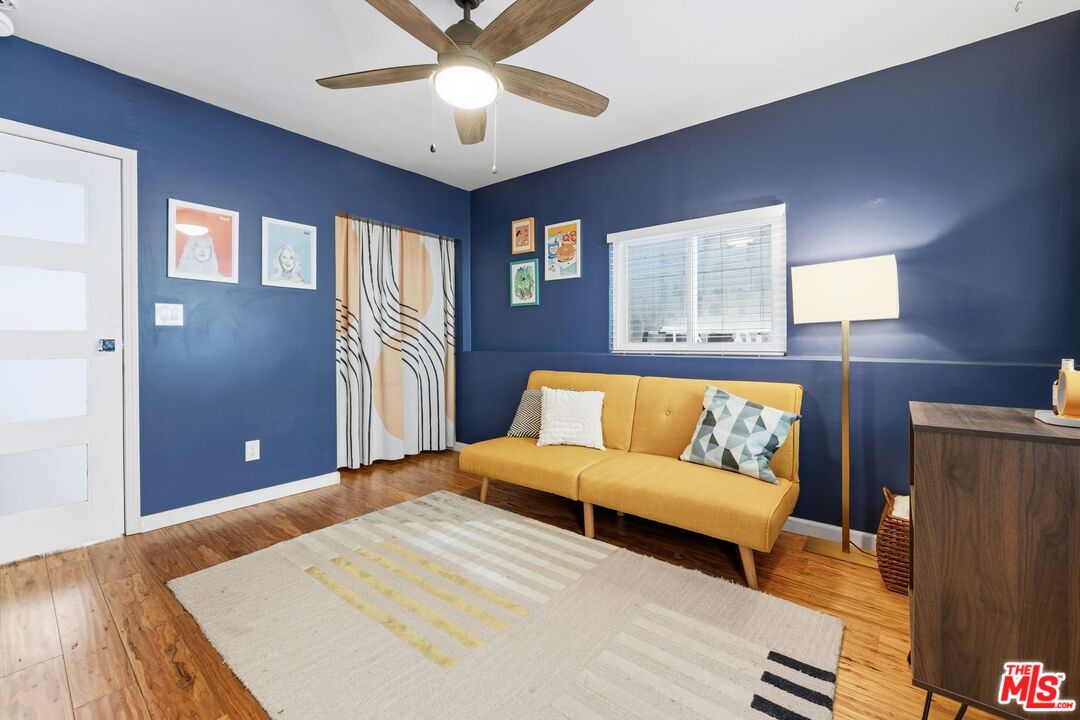 711 Bernard Street Los Angeles, CA 90012 - Photo 13 of 23 a bedroom with a large bed chandelier and a window