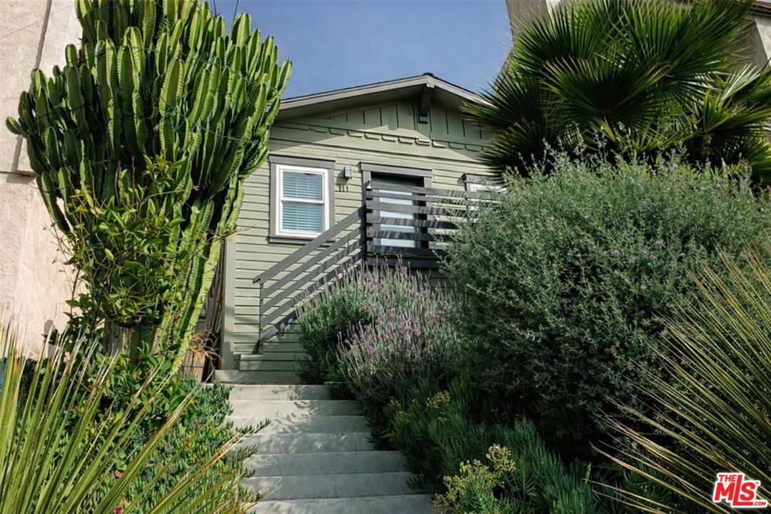 711 Bernard Street Los Angeles, CA 90012 - Photo 20 of 23 a front view of a house with a yard