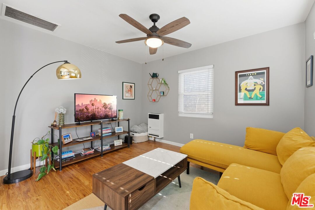 711 Bernard Street Los Angeles, CA 90012 - Photo 6 of 23 a living room with furniture and a flat screen tv