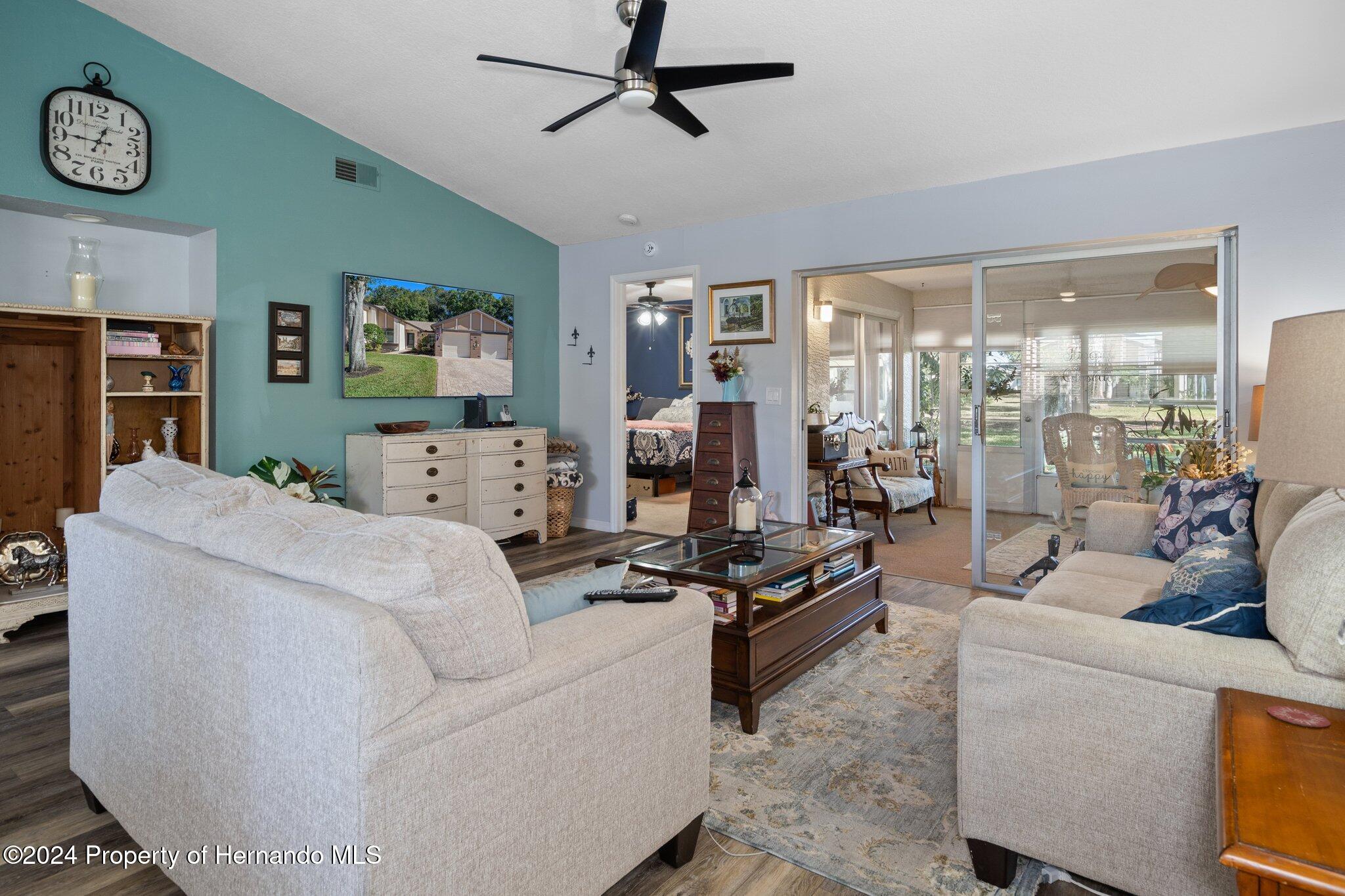 7427 Heather Walk Drive Spring Hill, FL 34613 - Photo 13 of 36 a living room with furniture and a flat screen tv